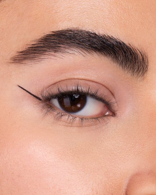 Step two of an eyeliner sequence: a thin line drawn along the lash line.