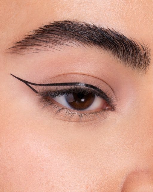 Step three of an eyeliner sequence: the wing extended and filled.