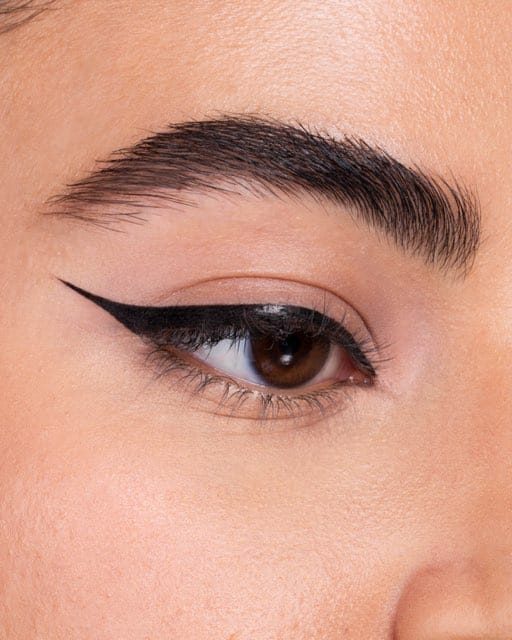 Step four of an eyeliner sequence: the finished double-wing graphic liner.