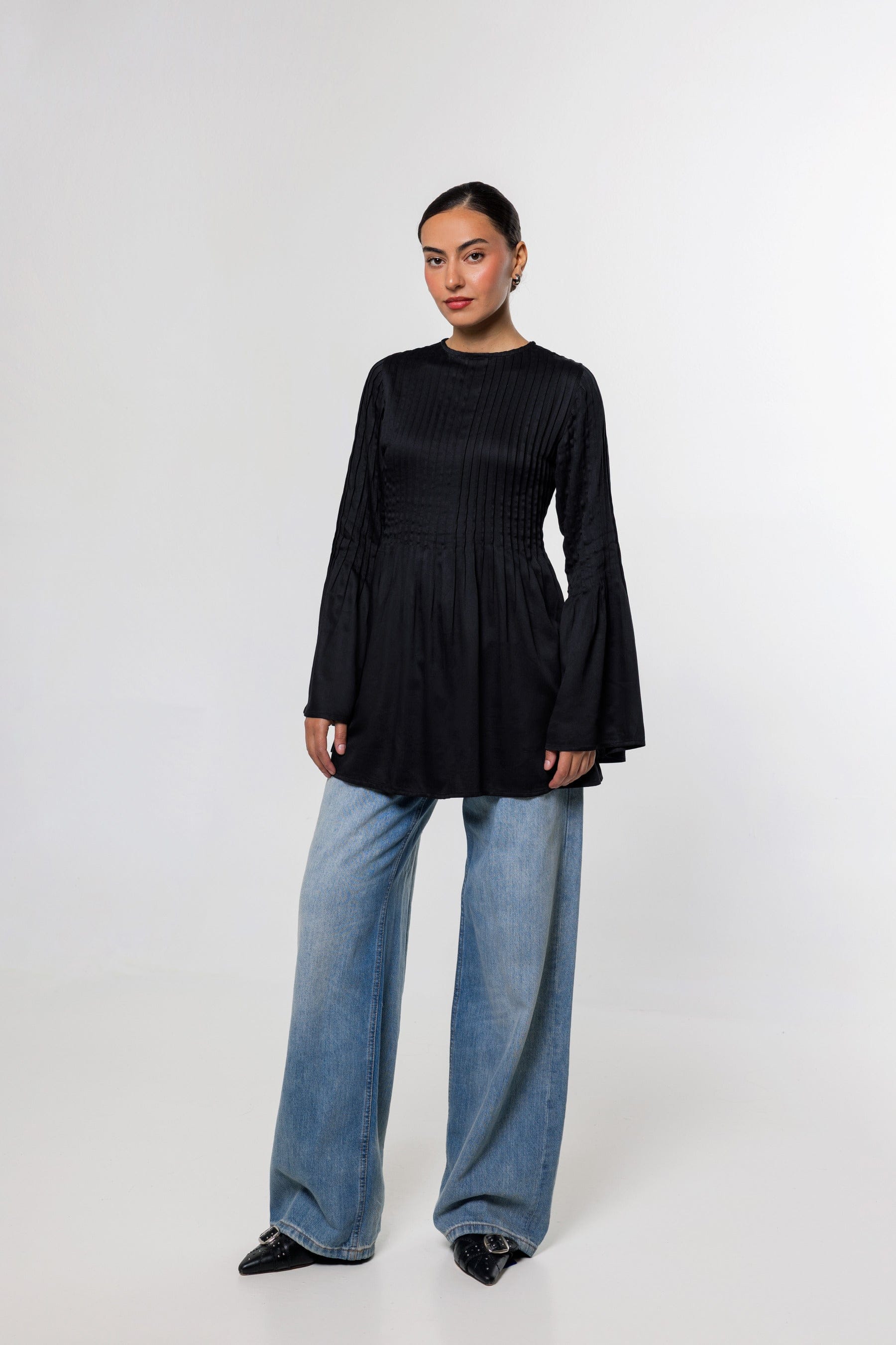 Campaign photograph of the Pintuck Top in black.
