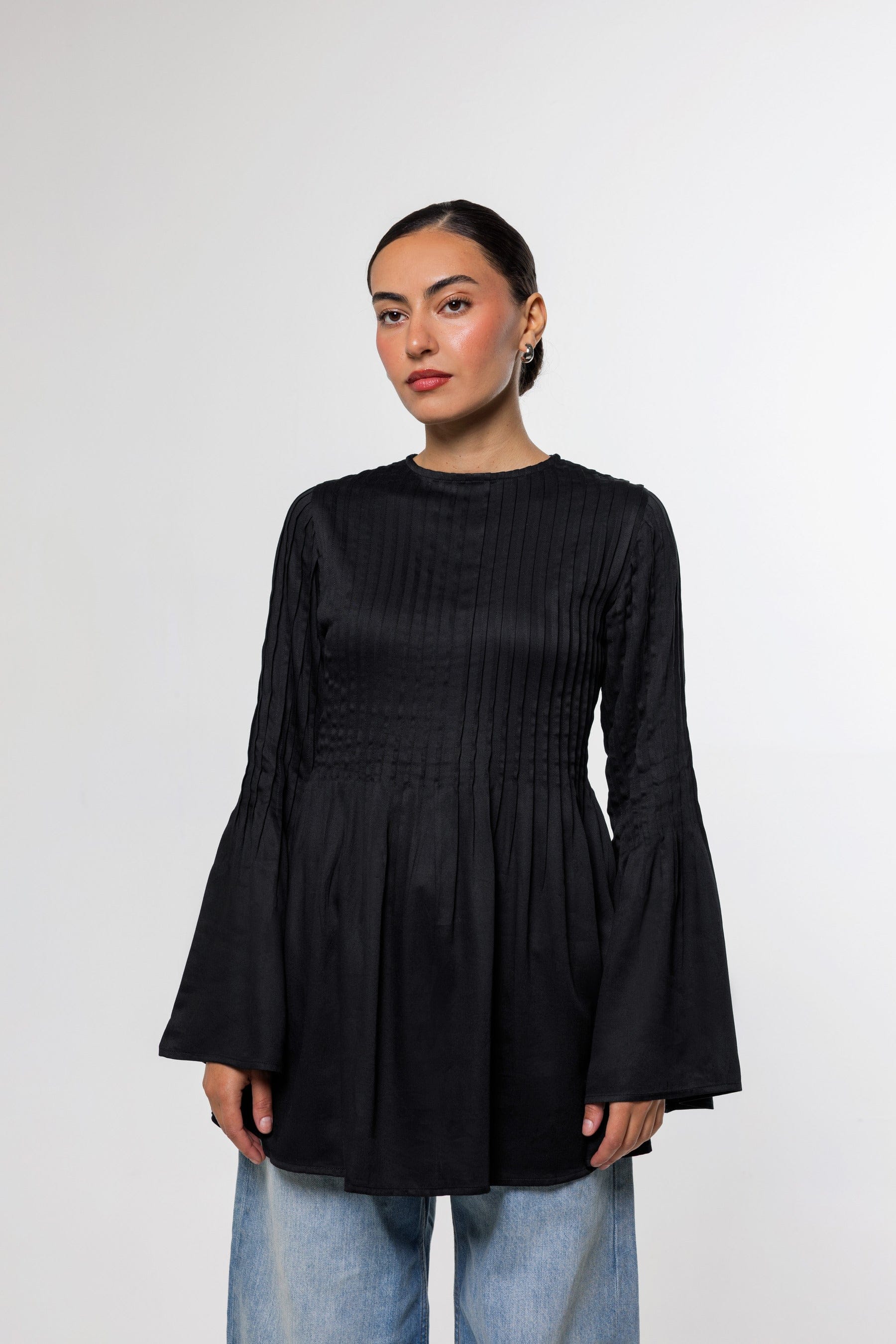 Campaign photograph of the Pintuck Top in black.